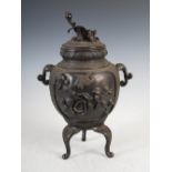 A Chinese bronze Ding censer and cover, the censer decorated with shaped panels enclosing Guanyin