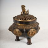 A Japanese bronze censer and cover, Meiji Period, the censer cast with shaped panels of relief