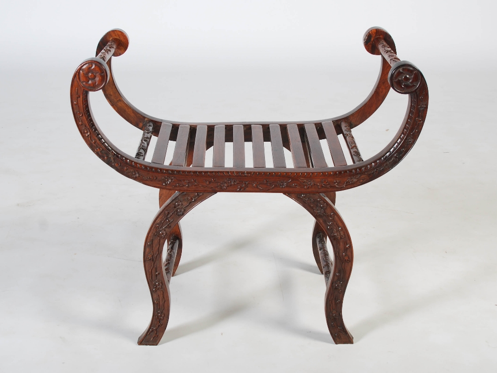 A Chinese dark wood X-frame stool, Qing Dynasty, carved with blossom, 71cm wide x 63cm high x 38cm - Image 2 of 4