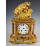 A late 19th century French ormolu and porcelain mounted mantel clock, the circular enamel dial