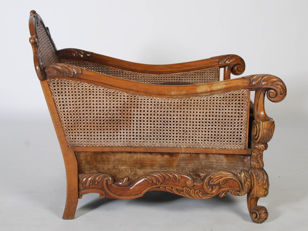 An Edwardian walnut three piece Bergere suite, comprising; three seat sofa and two armchairs, with - Image 7 of 7