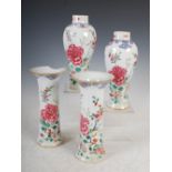 A garniture of four Chinese porcelain famille rose vases, Qing Dynasty, decorated with fenced