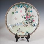 A Chinese porcelain dish, Republic Period, decorated with a fenced garden of rockwork, peony and