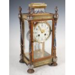 A late 19th century French onyx and champleve enamel mantel clock, the circular dial with Arabic