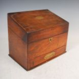 A 19th century walnut and brass inlaid stationery box, the hinged cover opening to a fitted interior