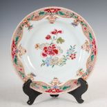 A Chinese porcelain famille rose plate, Qing Dynasty, decorated with peony spray within a foliate