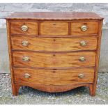 A George III mahogany and boxwood lined serpentine chest, the shaped top above three short and three