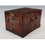 A Chinese dark wood and brass mounted vanity box, Qing Dynasty, the hinged rectangular cover opening