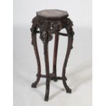 A Chinese octagonal shaped dark wood jardiniere stand, Qing Dynasty, the shaped top with a mottled