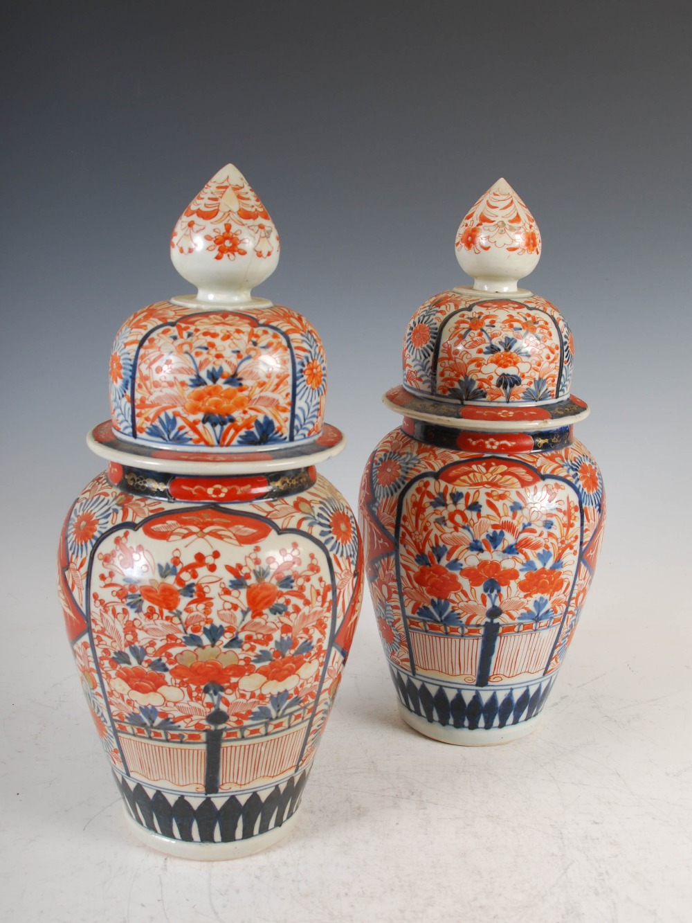 A pair of Japanese Imari porcelain jars and covers, Meiji Period, 39cm high