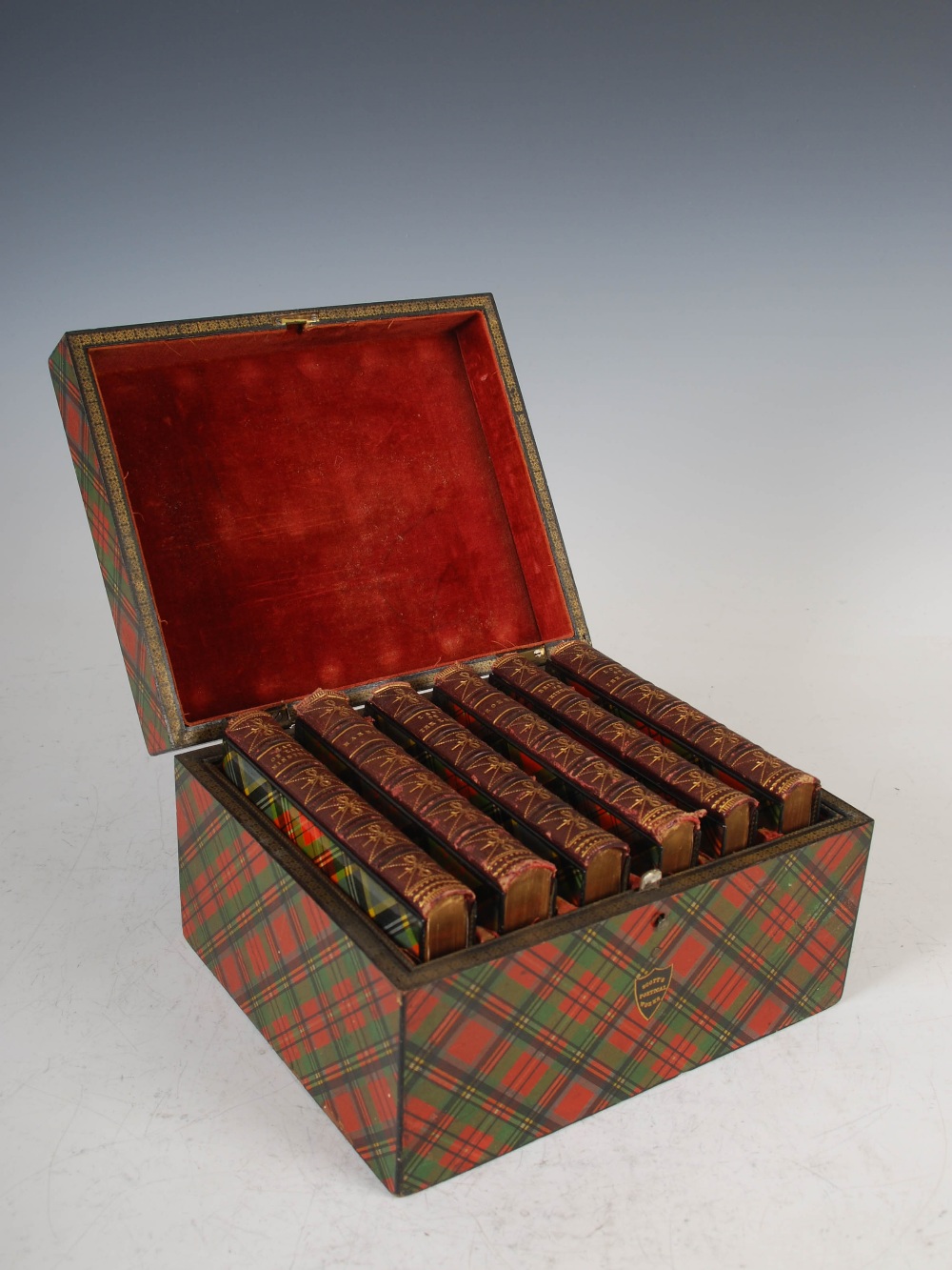 A 19th century tartan ware box containing six tartan ware bound volumes of Scott's Poetical Works,