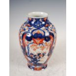 A Japanese Imari vase, Meiji Period, decorated with panels of flowers and foliage on a ground of