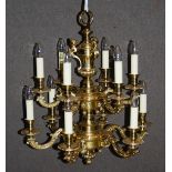 A 20th century brass twelve light chandelier, the central column with three caryatid supports