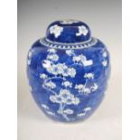 A Chinese porcelain blue and white jar and cover, Qing Dynasty, decorated with prunus blossom on a