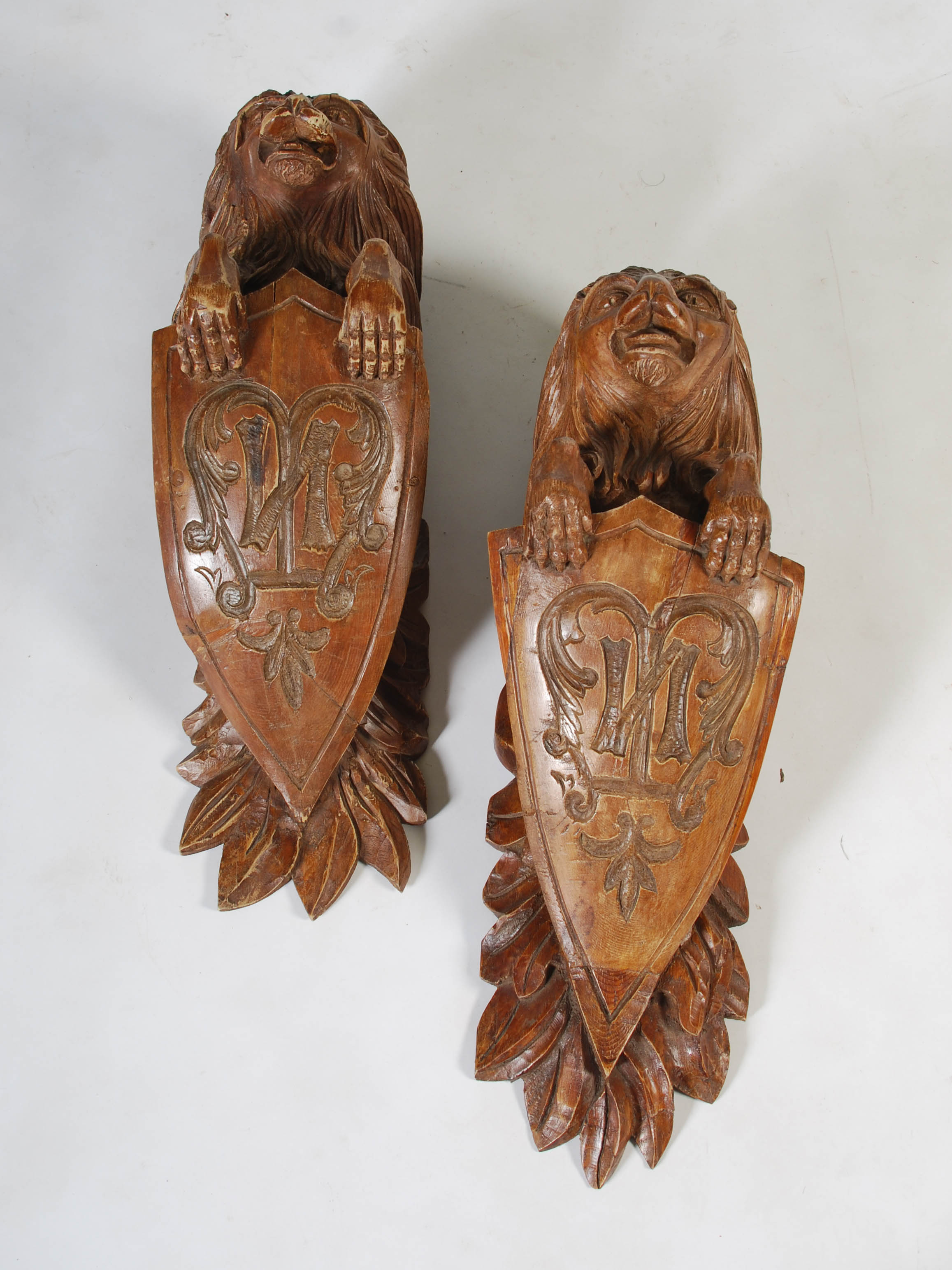 A pair of late 19th century carved pine brackets, carved with lions supporting shields carved with - Image 2 of 7