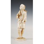 A Japanese ivory okimono of a woodsman, Meiji Period, the male figure standing holding a bundle of