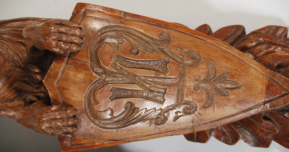A pair of late 19th century carved pine brackets, carved with lions supporting shields carved with - Image 6 of 7