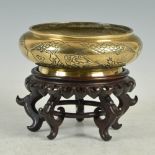 A Chinese bronze censer, bearing Xuande six character mark, the sides incised with three oval shaped