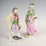 A pair of Dresden porcelain figures, depicting 19th century figures, the male wearing yellow and