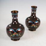 A pair of Chinese black ground cloisonne bottle vases, decorated with stylised flowers and scrolling