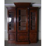 A Victorian oak breakfront bookcase, with moulded cornice and dentil frieze above a central