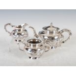 A late 19th century Chinese silver three piece tea set, Qing Dynasty, comprising; teapot, twin