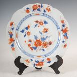 A Chinese porcelain Imari plate, Qing Dynasty, decorated with foliate sprays within a diaper and