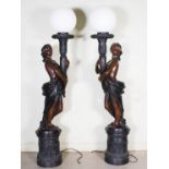 A pair of decorative 20th century bronze figural torcheres, cast with semi clad maidens holding