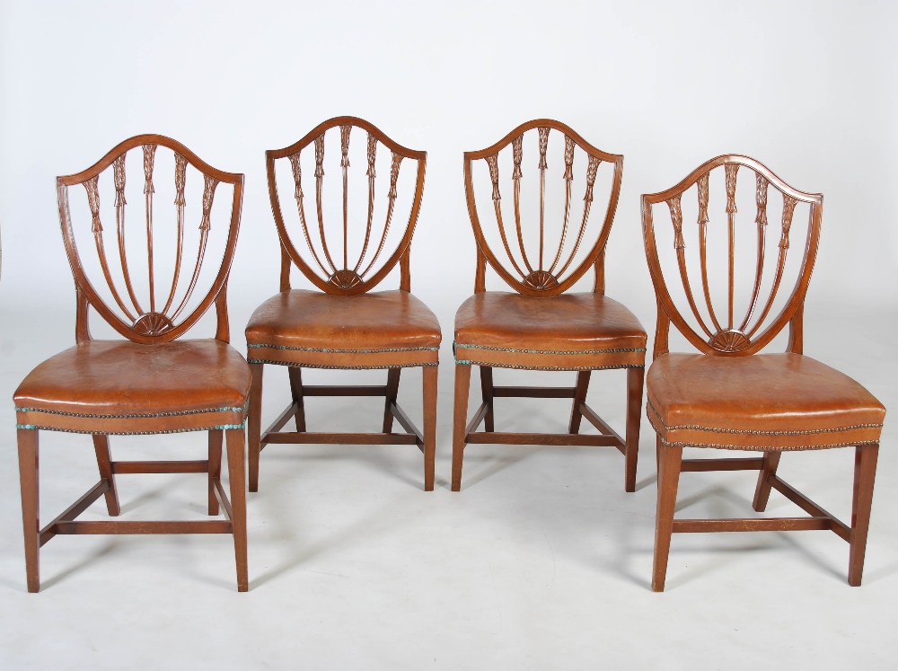 A set of ten early 20th century mahogany Hepplewhite style dining chairs, the shield shaped backs