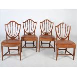 A set of ten early 20th century mahogany Hepplewhite style dining chairs, the shield shaped backs