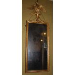 A 19th century gilt wood wall mirror, the silvered mirror plate within a beaded and foliate carved