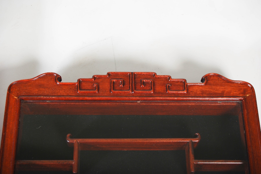 A pair of Chinese dark wood wall mounted display cabinets, the glazed cupboard doors opening to - Image 4 of 5