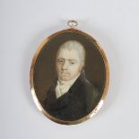 A 19th century portrait miniature of a gentleman, oval half length, painted on ivory, the reverse