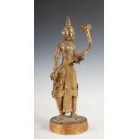 A Burmese gilt bronze figure of a musician, late 19th century, modelled standing holding a horn,