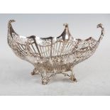 A George V silver basket, London, 1921, makers mark D.F., oval shaped with pierced scrollwork sides,