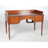 An early Victorian mahogany wash stand, the rectangular top with three quarter gallery above a