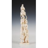 A Japanese ivory okimono of man and boy, Meiji Period, the male figure holding aloft a pole