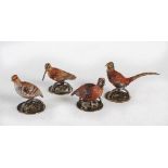 A set of four early 20th century cold painted bronze menu card holders, cast in the form of a