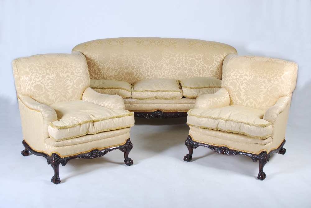 A 20th century mahogany three piece suite, comprising; three seat sofa and two armchairs, all