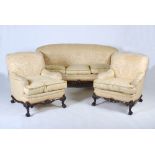 A 20th century mahogany three piece suite, comprising; three seat sofa and two armchairs, all