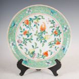 A Chinese porcelain plate, late Qing Dynasty, decorated with finger citrus, flowers and foliage