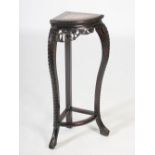 A Chinese dark wood corner shaped jardiniere stand, Qing Dynasty, the shaped top with a mottled