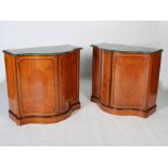 A pair of early 20th century satinwood serpentine side cabinets, the green and white marble tops