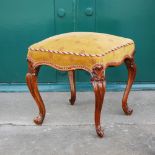 A Victorian walnut square shaped dressing table stool, the serpentine upholstered seat raised on