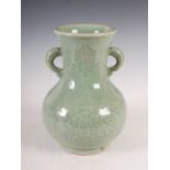 A Chinese porcelain celadon glazed archaic style vase, incised with peony and scrolling foliage, the