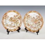 A pair of Japanese Kutani twin handled cabinet plates, decorated with figures and pavilions in a