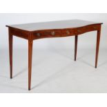 A George III mahogany and boxwood lined serpentine serving table, the shaped rectangular top above