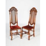 A pair of late 19th/early 20th century Continental walnut hall chairs, the upright backs with