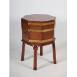 A reproduction George III mahogany and brass bound octagonal shaped wine cooler, the hinged cover