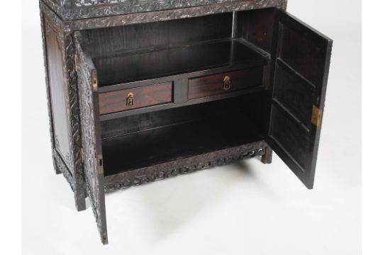 A Chinese dark wood display cabinet, Qing Dynasty, the upper section with six open shelves within - Image 6 of 6